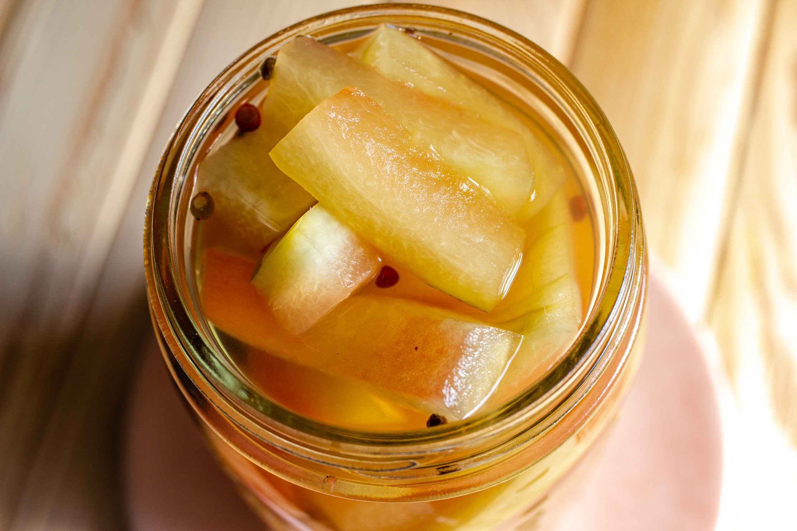 Jar of watermelon rinds in liquid.