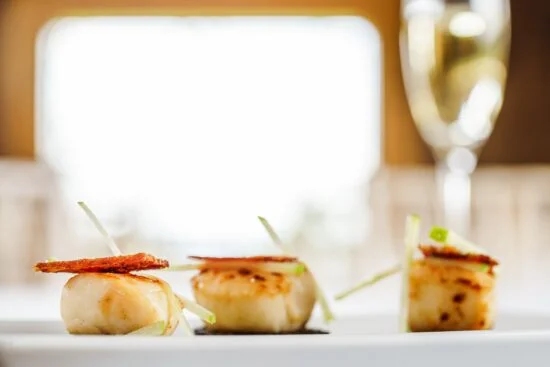 Scallops on a white plate.