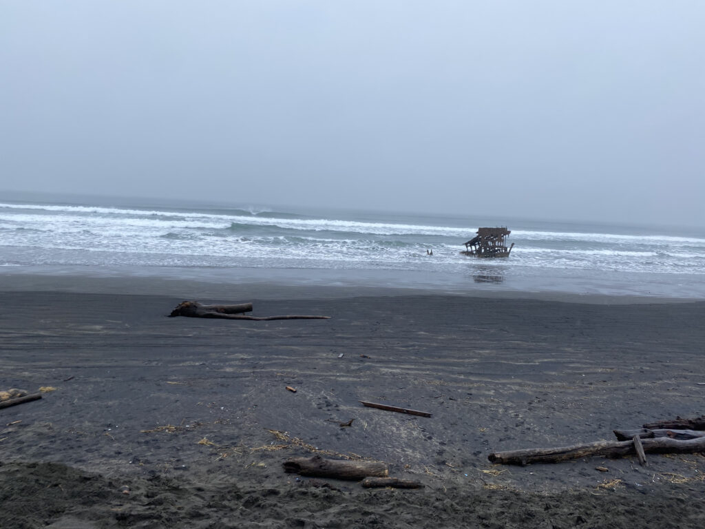 An old shipwreck on a beach on a stormy day.