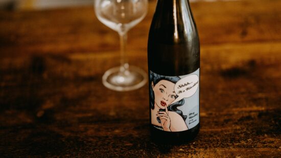 Bottle of wine with a label of an animated woman on it.