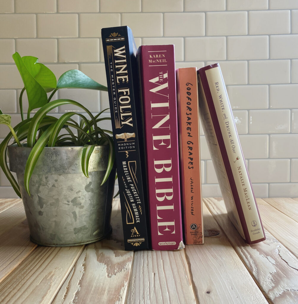 A stack of books balanced on a plant.