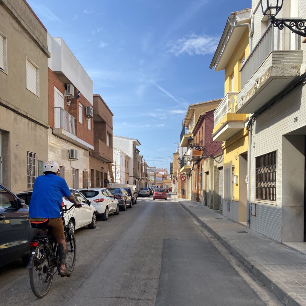 A man riding a bike down a street.